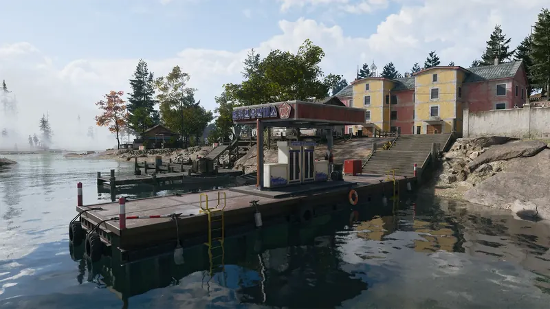 Small waterfront fuel station on a floating dock, with boats, wooden piers, and stairs leading to nearby buildings.