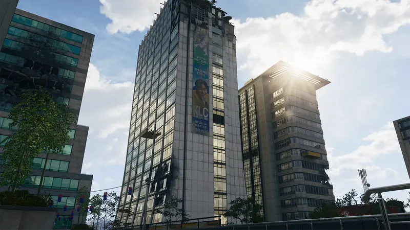 Tall glass office towers with damaged windows and a large Korean advertisement rise above a city street.