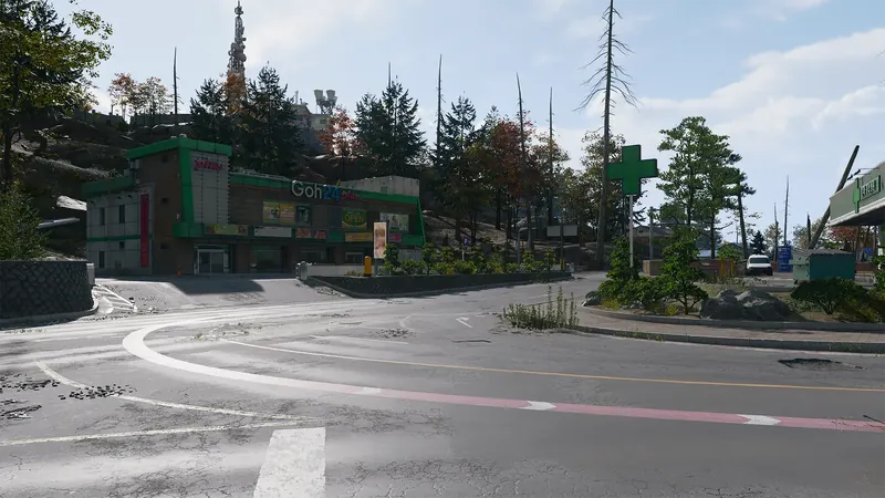 Goh24 Plus convenience store and pharmacy sit along a curved road beneath a wooded hillside and communications tower.