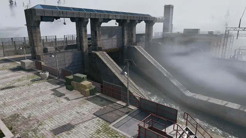 Massive concrete dam with steep spillways, industrial structures, and mist rising above the water.